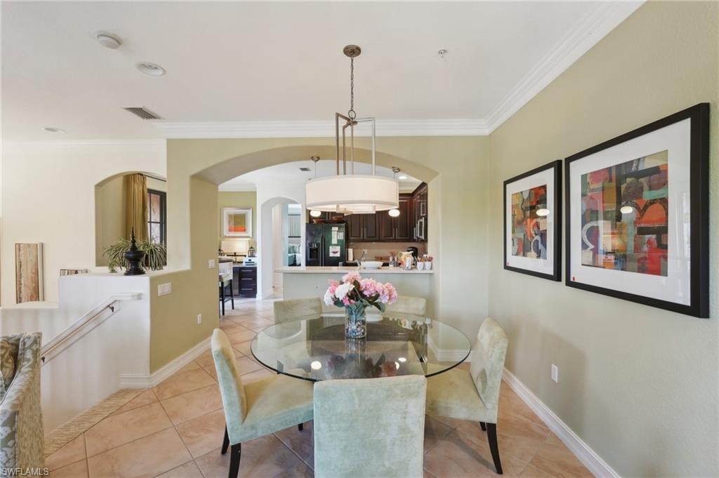9108 Capistrano Street South, Unit 7401 Naples, FL 34113 - Photo 9 of 44 a dining room with furniture and window