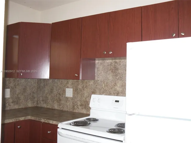 a close view of a sink a counter space and a window