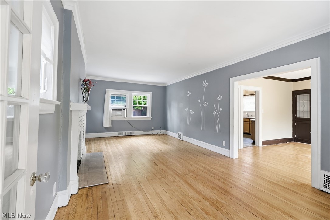 3511 Northcliffe Road Cleveland, OH 44118 - Photo 3 of 46 Hardwood flooring, decorative fireplace, white trim, and a wide entryway