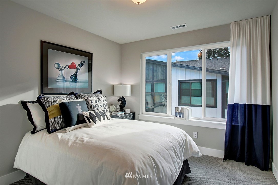 9620 Main Street, Unit 5A Bothell, WA 98011 - Photo 14 of 18 a bedroom with a large bed and a large window