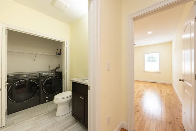 a view of a bedroom with washer and dryer