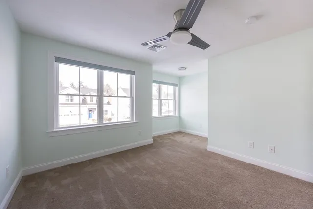 an empty room with a empty space and windows