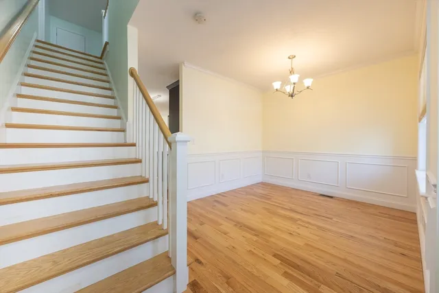 a view of a room with stairs and wooden floor