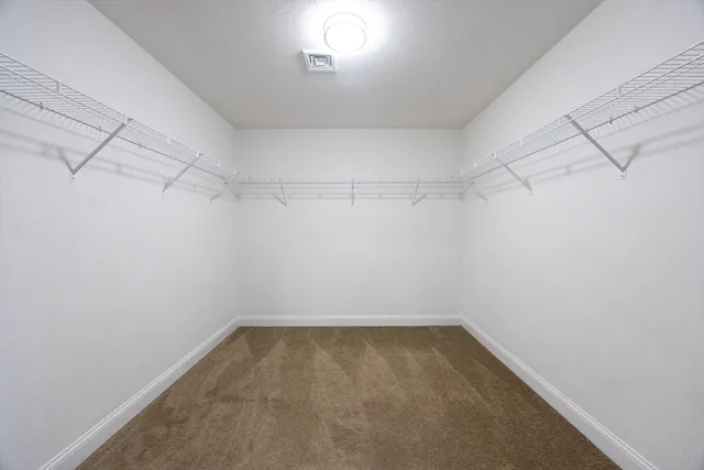 a view of a balcony with wooden floor and windows