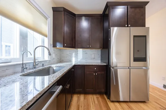 a kitchen with a refrigerator and a sink