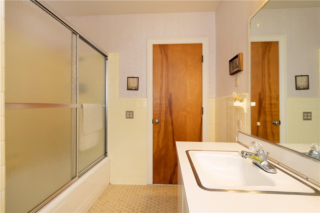 118 Blair Road Belton, SC 29627 - Photo 32 of 49 Classic tiling and a wood-toned door create a warm, retro feel in this bathroom.