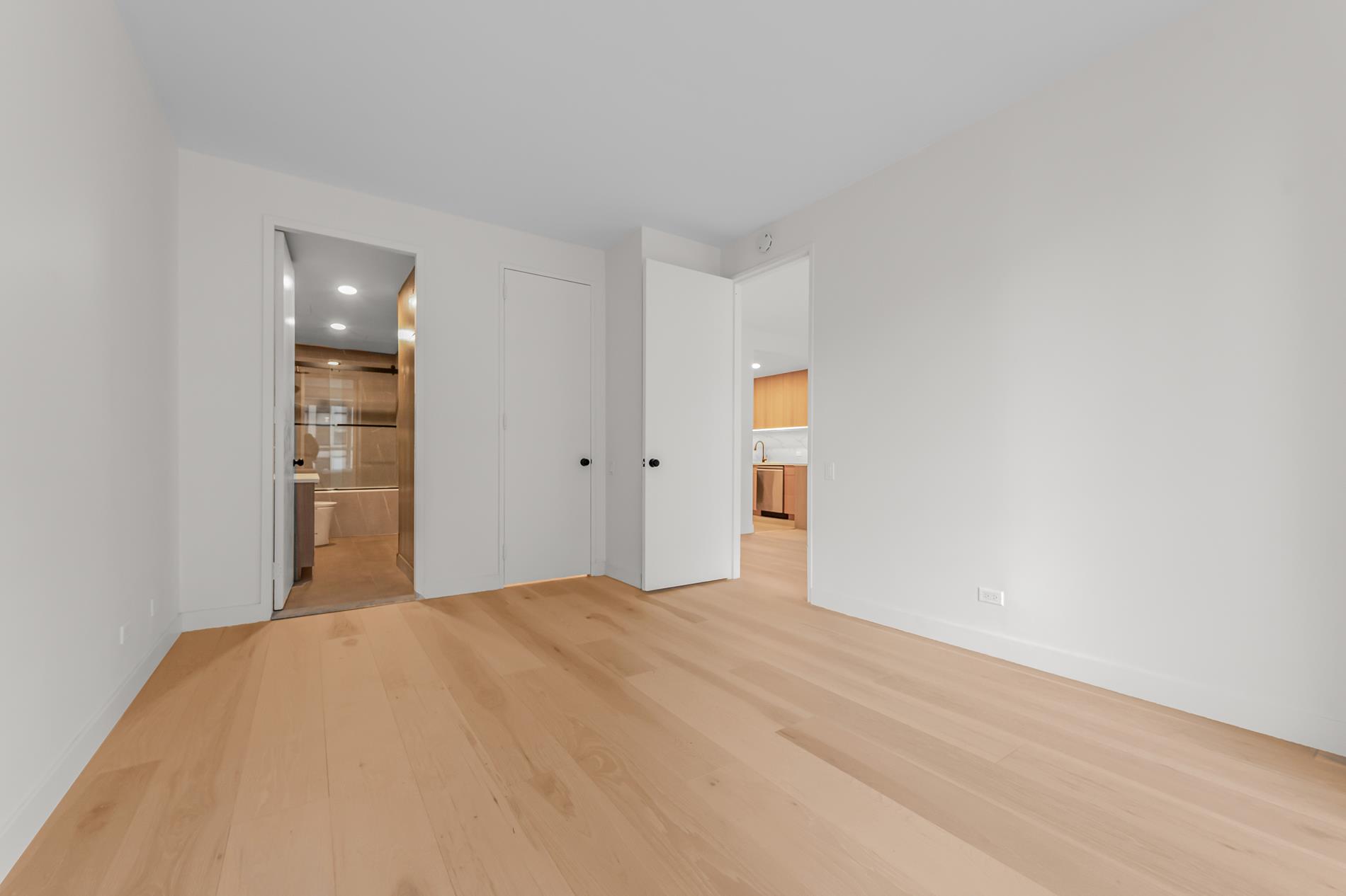 146 West 57th Street, Unit 52E Manhattan, NY 10019 - Photo 11 of 19 a bedroom with a bed and closet