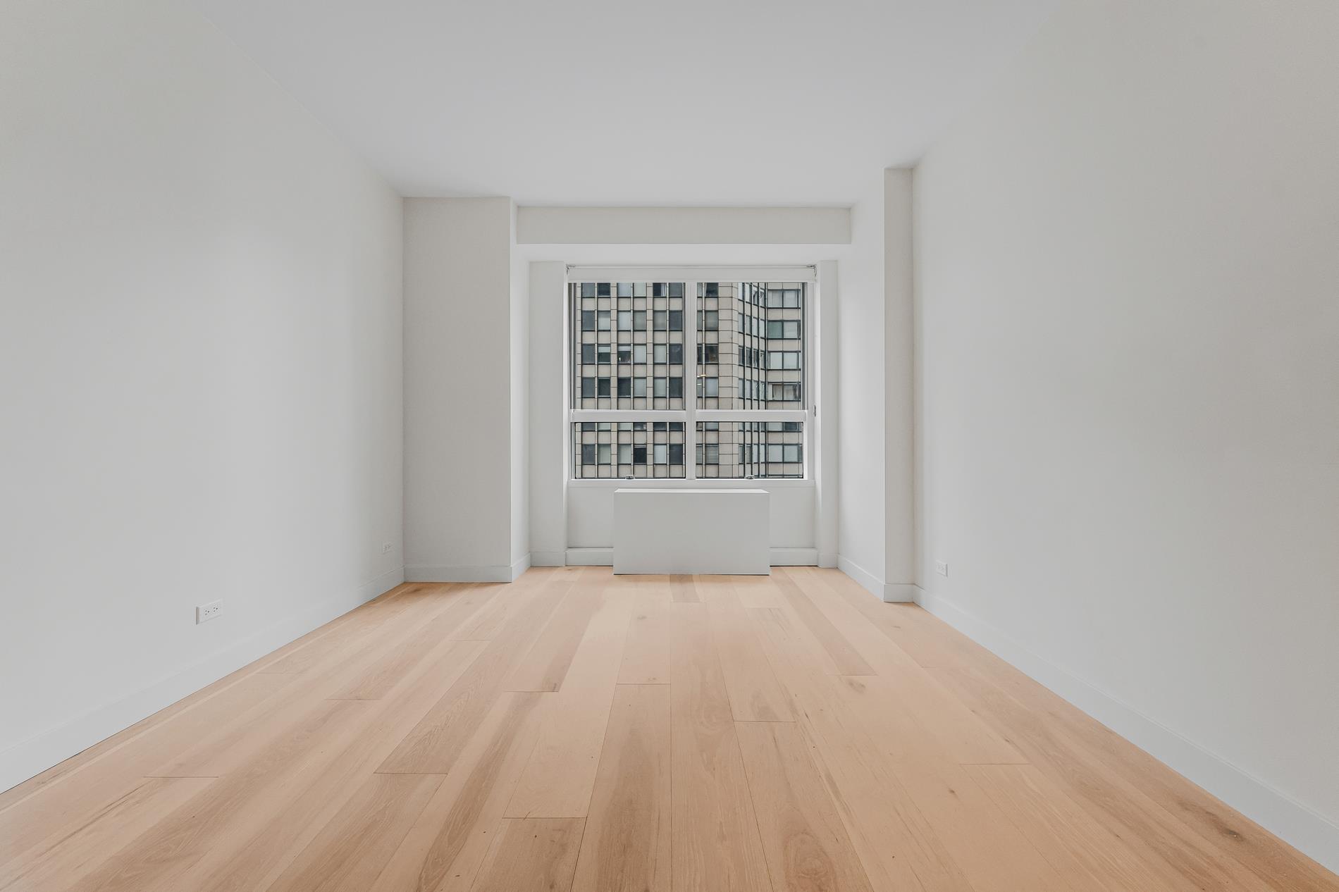 146 West 57th Street, Unit 52E Manhattan, NY 10019 - Photo 12 of 19 a view of an empty room with windows