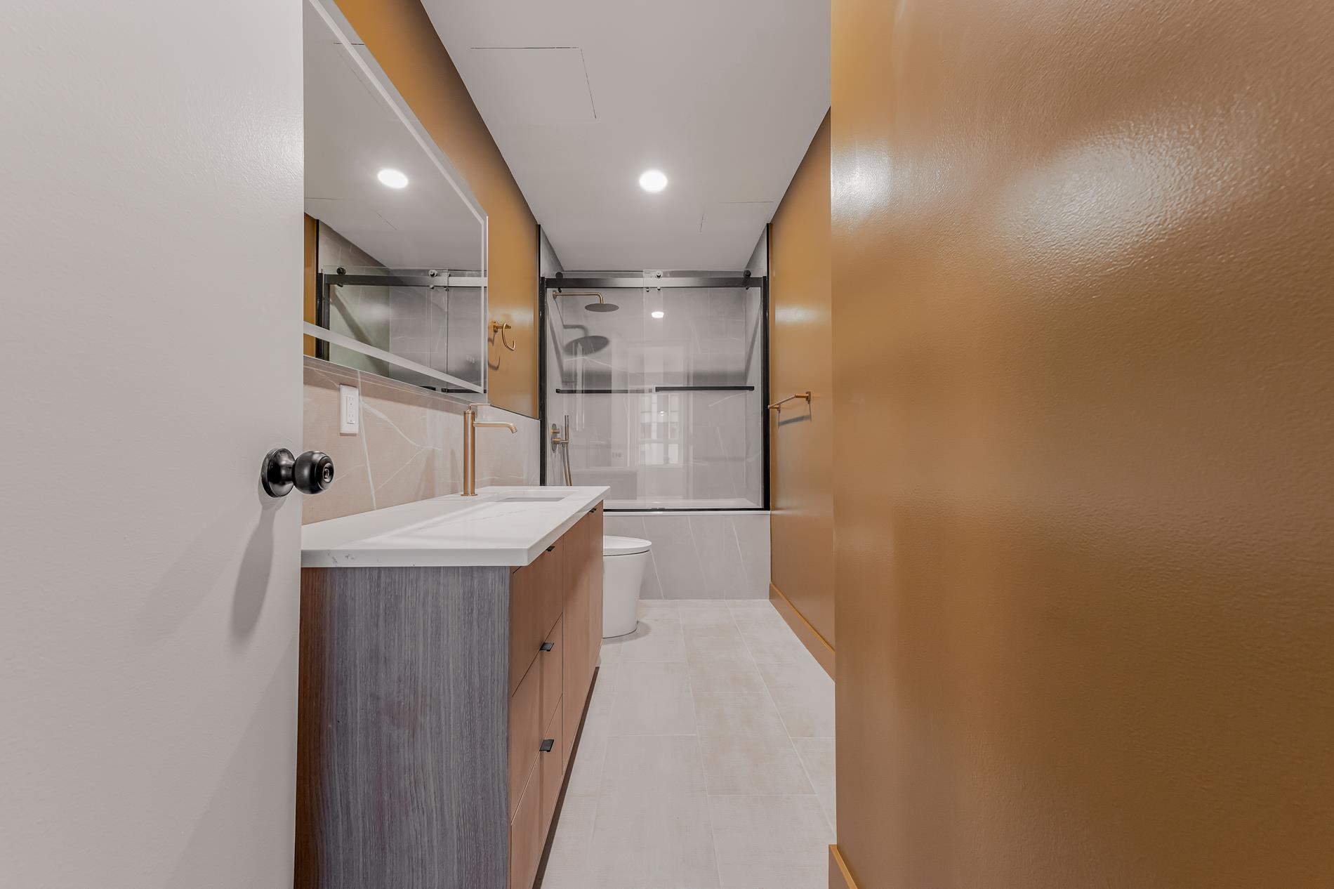 146 West 57th Street, Unit 52E Manhattan, NY 10019 - Photo 13 of 19 a bathroom with a sink and mirror