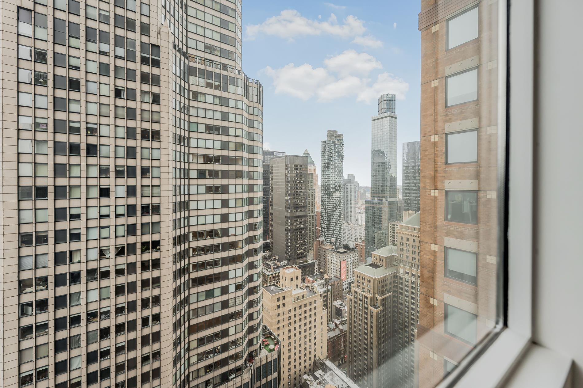 146 West 57th Street, Unit 52E Manhattan, NY 10019 - Photo 15 of 19 a view of a city with tall buildings