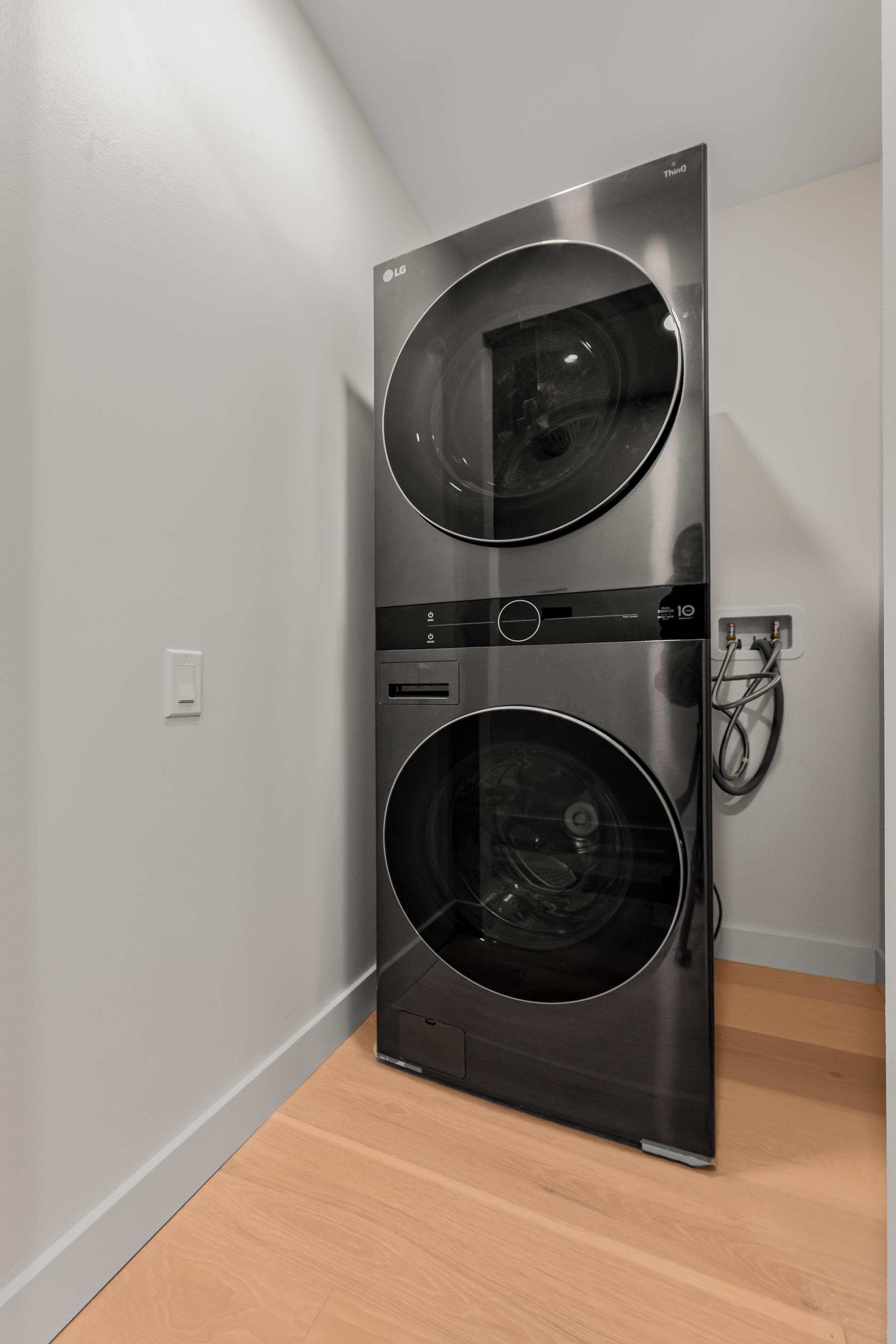 146 West 57th Street, Unit 52E Manhattan, NY 10019 - Photo 8 of 19 a utility room with dryer and washer