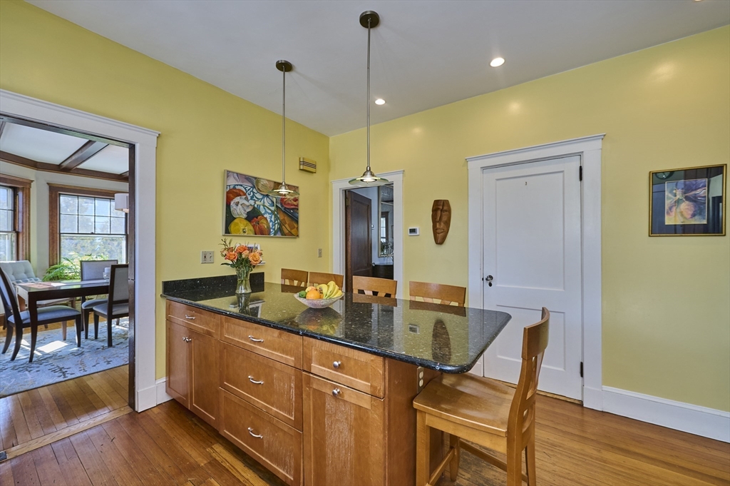 132 Windermere Road Auburndale, MA 02466 - Photo 12 of 38 a dining hall with stainless steel appliances granite countertop a dining table chairs and a refrigerator