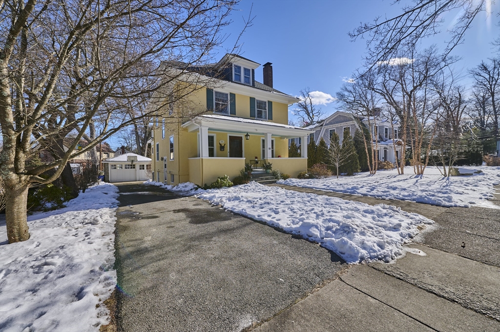 132 Windermere Road Auburndale, MA 02466 - Photo 2 of 38 a front view of a house with a yard covered in snow