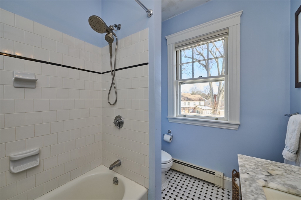 132 Windermere Road Auburndale, MA 02466 - Photo 25 of 38 a bathroom with a granite countertop bathtub a shower and a window