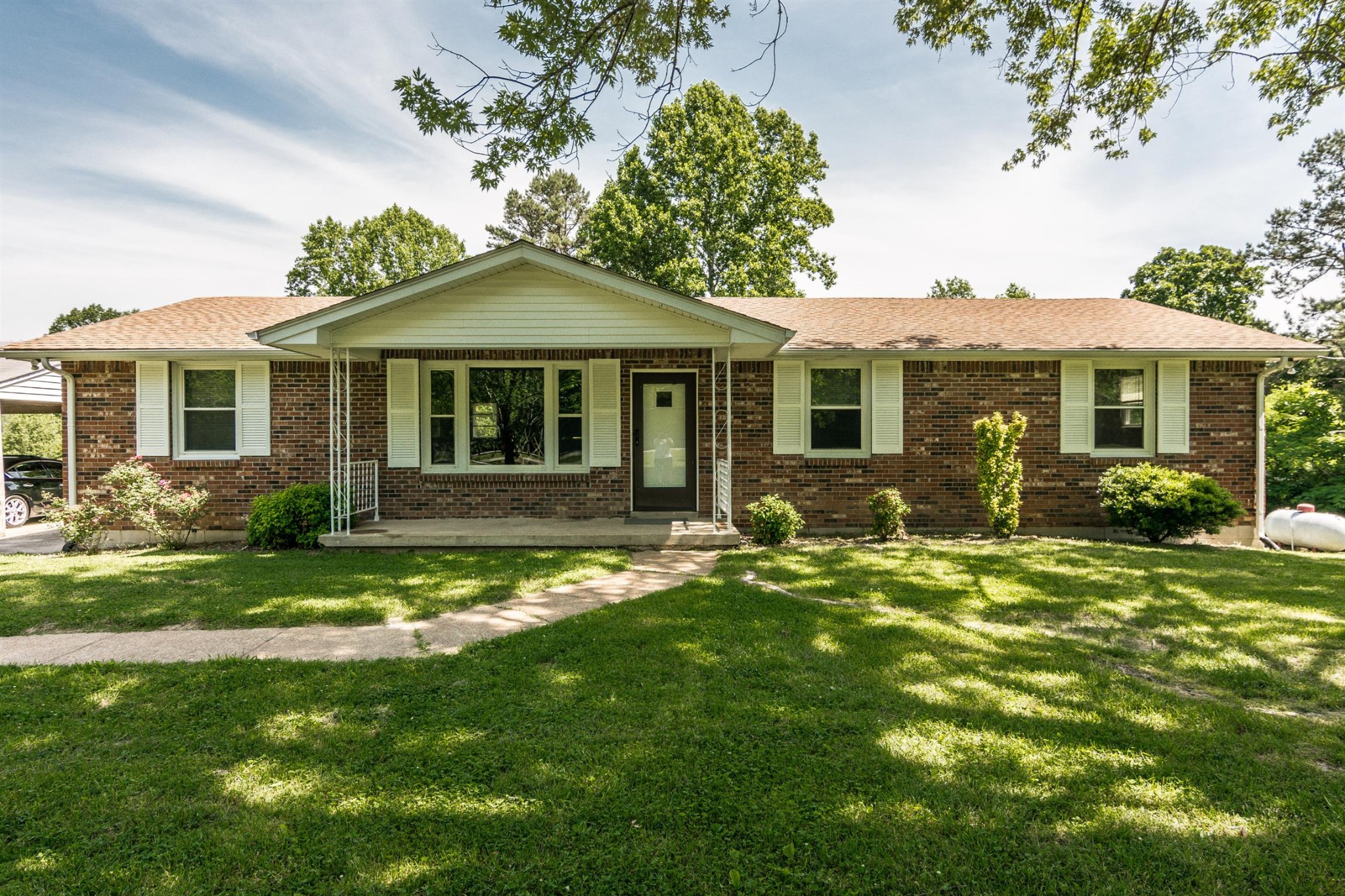 a front view of a house with a garden
