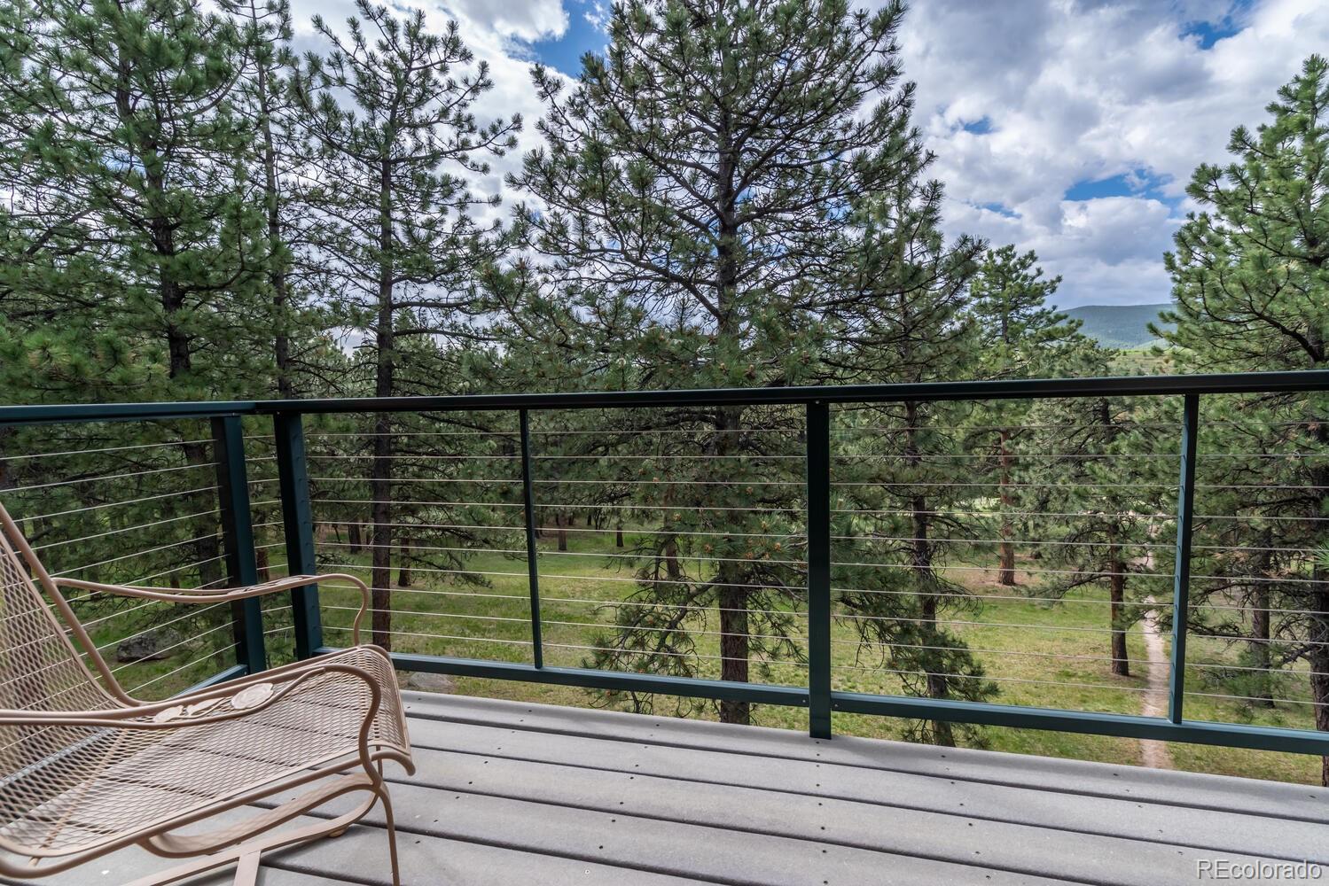 498 Mountain Meadows Road Boulder, CO 80302 - Photo 14 of 40 a view of a balcony with wooden floor and fence