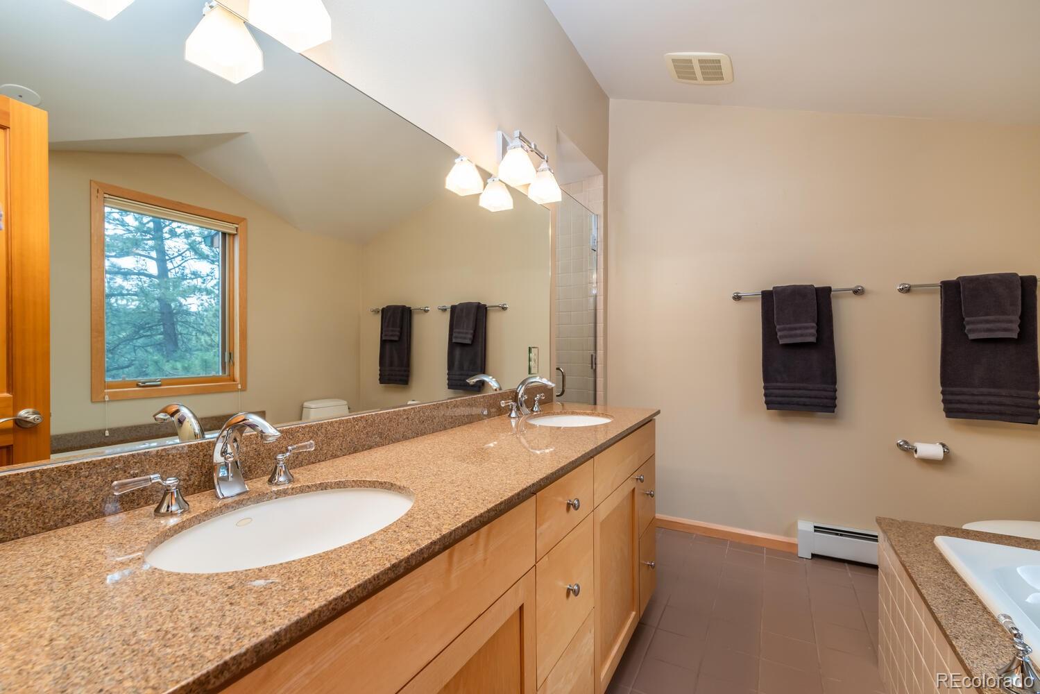 498 Mountain Meadows Road Boulder, CO 80302 - Photo 16 of 40 a bathroom with 2 sink and a mirror