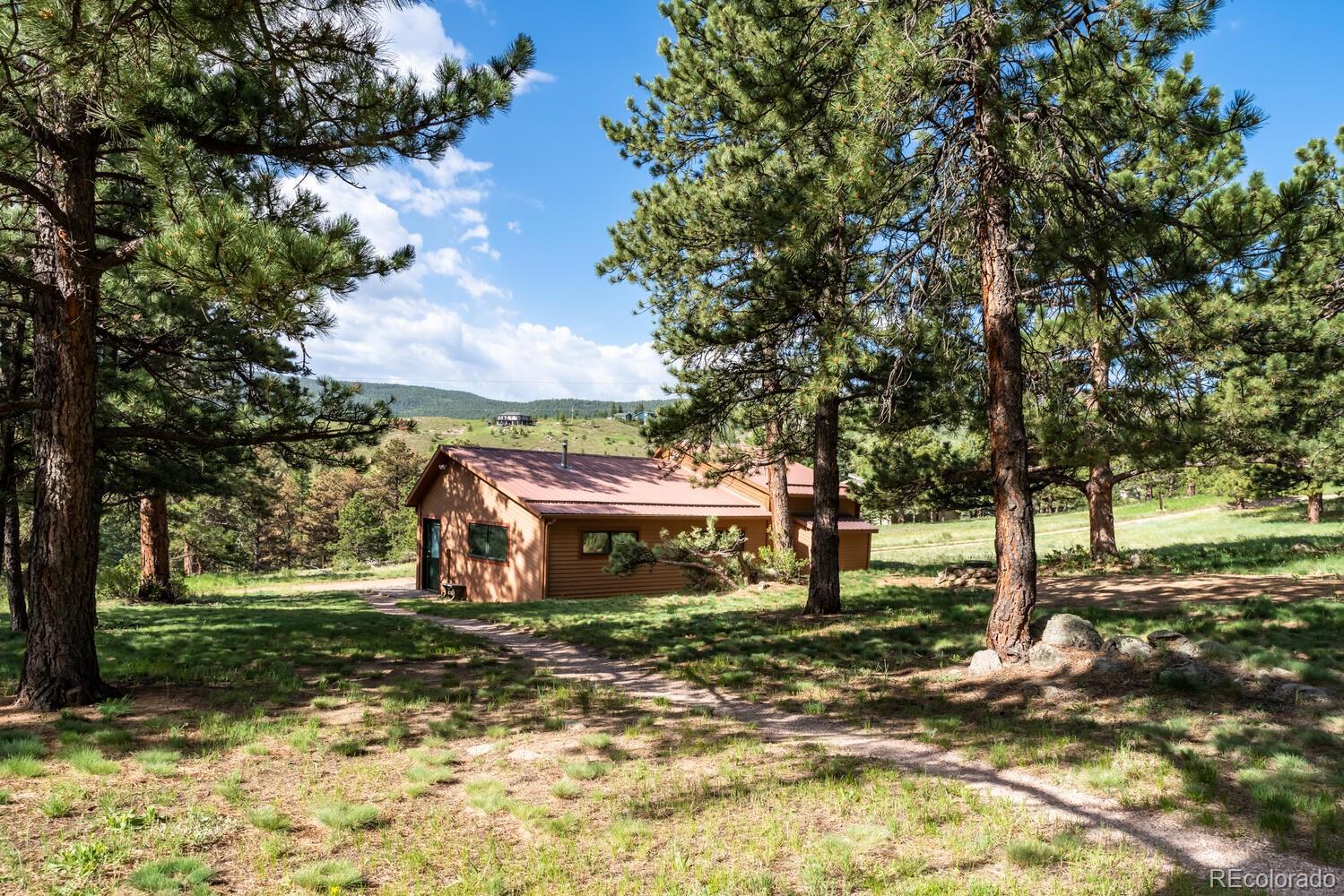 498 Mountain Meadows Road Boulder, CO 80302 - Photo 26 of 40 a front view of a house with a yard