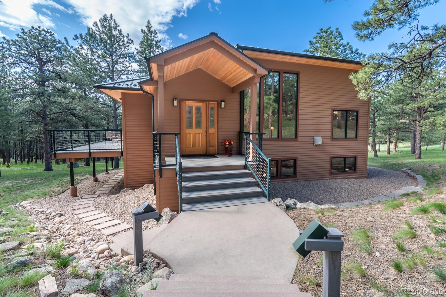 498 Mountain Meadows Road Boulder, CO 80302 - Photo 3 of 40 a front view of a house with a porch