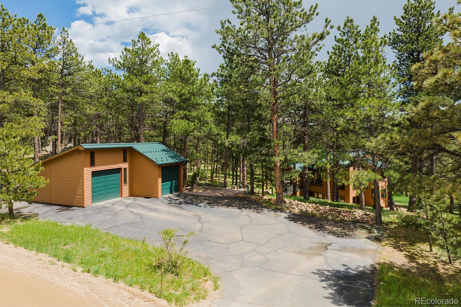 498 Mountain Meadows Road Boulder, CO 80302 - Photo 34 of 40 a view of a house with a yard