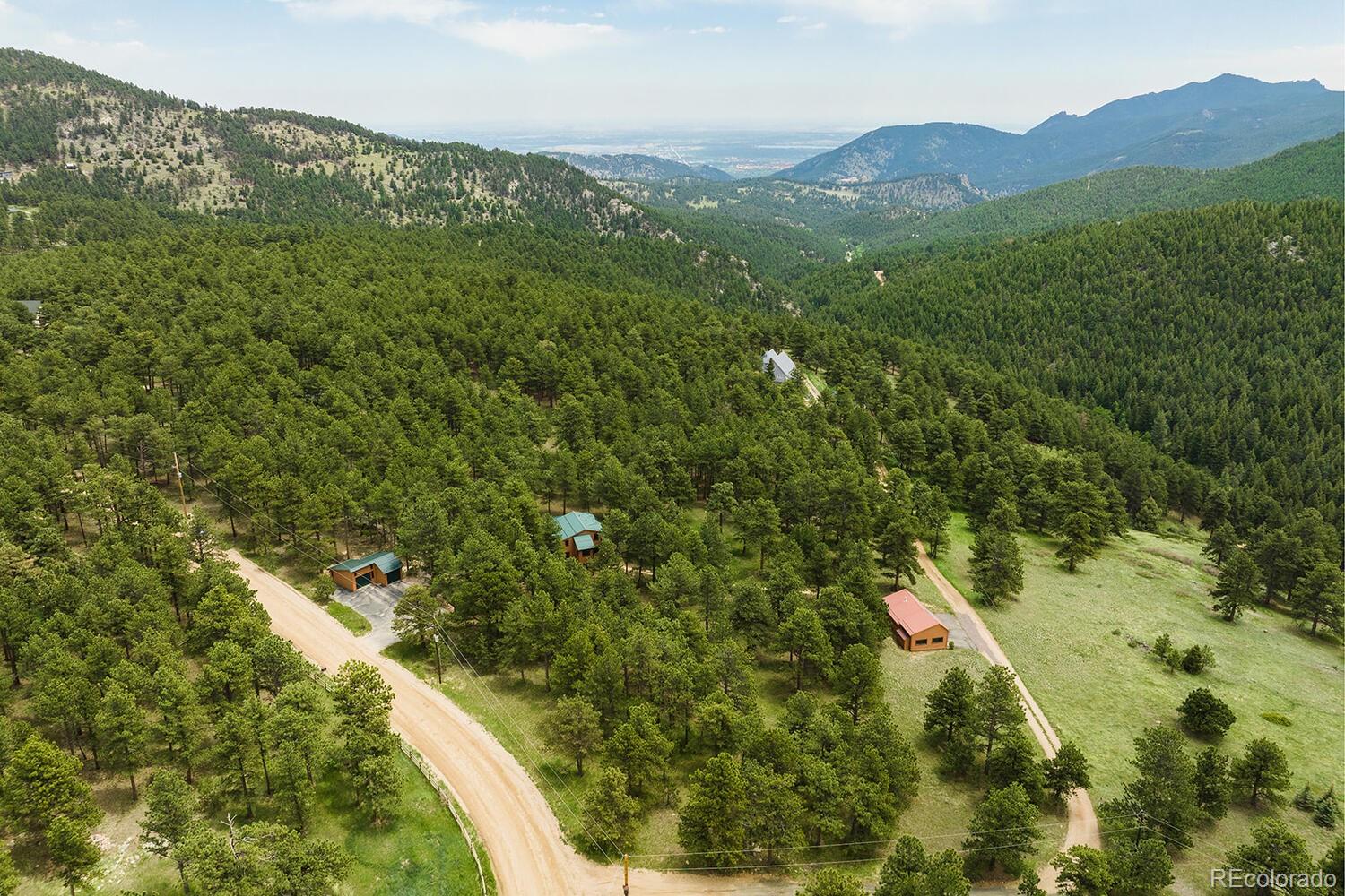498 Mountain Meadows Road Boulder, CO 80302 - Photo 38 of 40 a view of a lush green hillside and a building