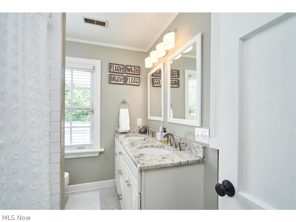 39 North Wheaton Road Akron, OH 44313 - Photo 26 of 38 Bathroom with tile flooring, vanity, toilet, and crown molding