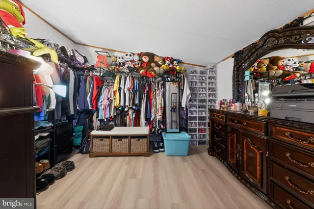 a view of walk in closet with clothes