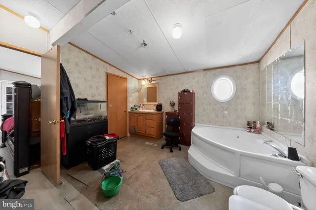 a bathroom with a tub sink and mirror
