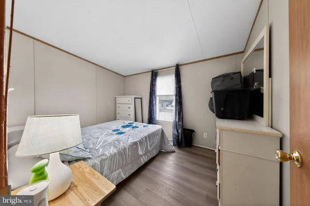 a bedroom with a bed a flat screen tv and view