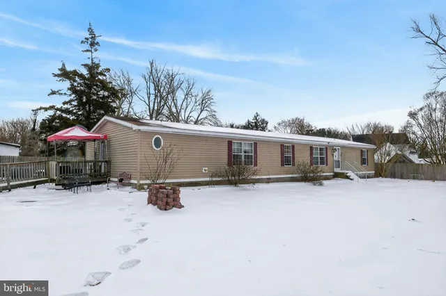 a view of a house with a snow in the yard