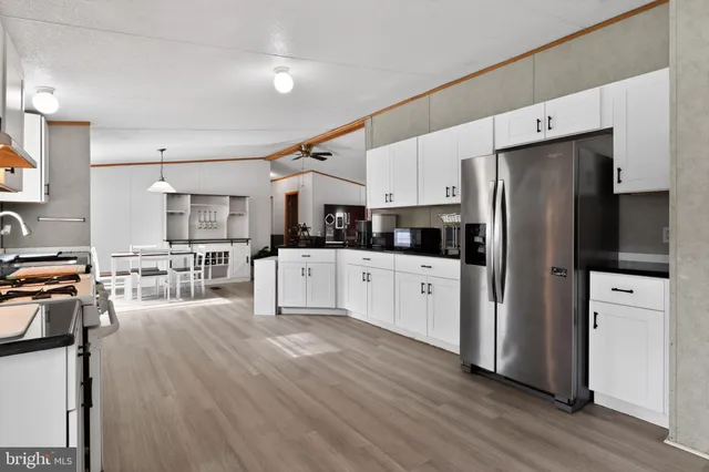 a kitchen with stainless steel appliances a refrigerator sink and cabinets
