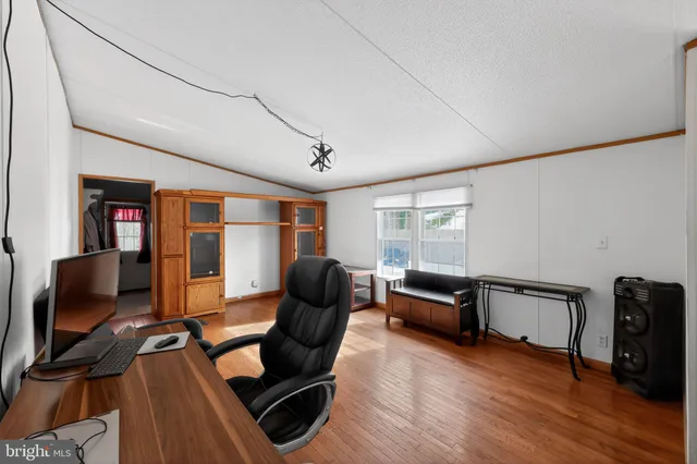 a livingroom with workspace and a couch