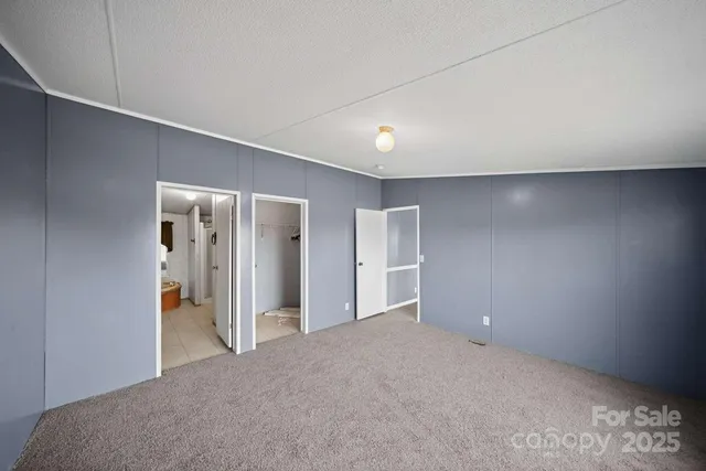 a view of hallway with closet and bathroom