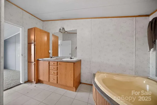 a bathroom with a tub a mirror and a shower