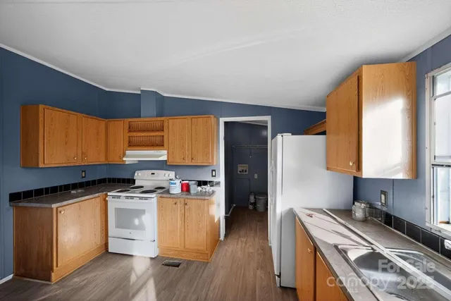 a kitchen with a stove a sink and a refrigerator