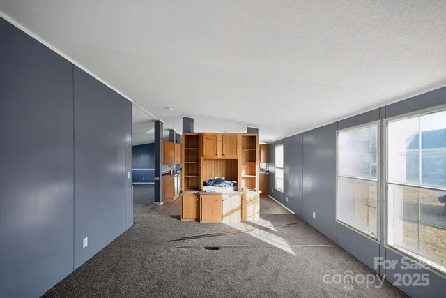 a view of kitchen with refrigerator and window