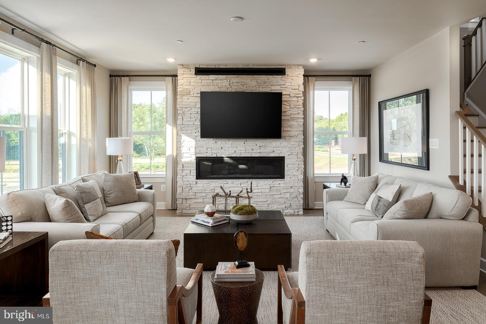 3100 Brazier Lane Exton, PA 19341 - Photo 2 of 35 a living room with furniture fireplace and a flat screen tv