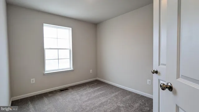 a view of kitchen with stainless steel appliances granite countertop a refrigerator a sink dishwasher and a refrigerator with wooden floor