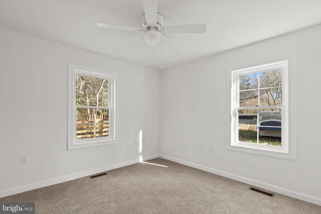 an empty room with windows and closet