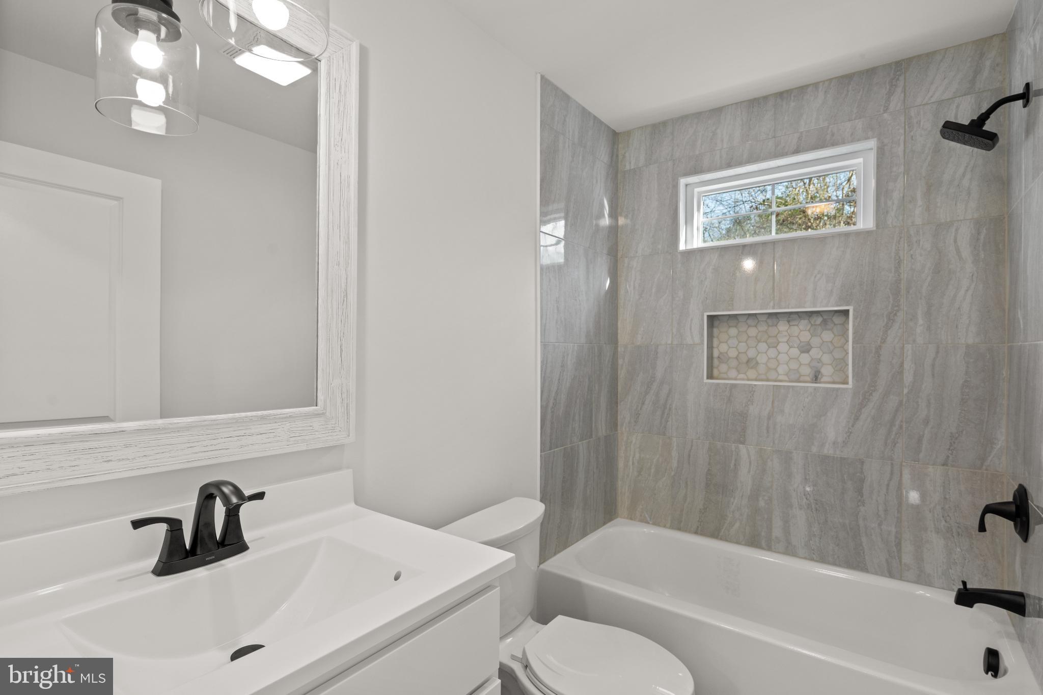 22202 Wetipquin Road Quantico, MD 21856 - Photo 17 of 28 a bathroom with a sink a toilet and bathtub