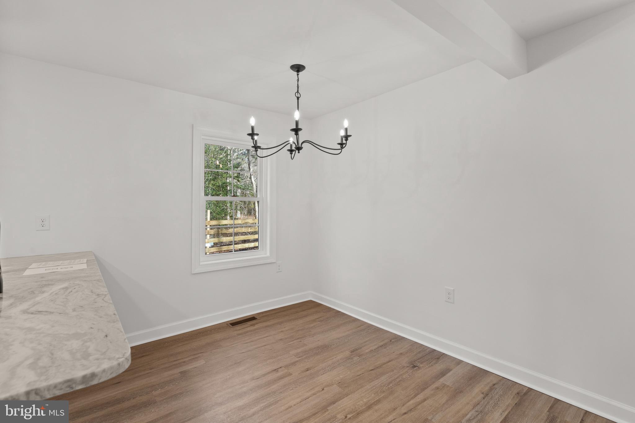 22202 Wetipquin Road Quantico, MD 21856 - Photo 25 of 28 wooden floor in an empty room with a window