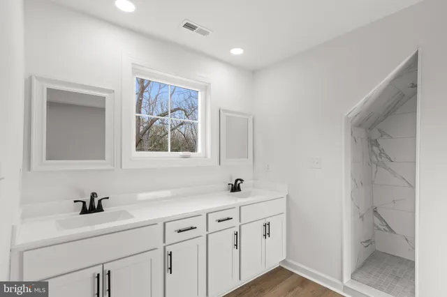 a bathroom with 2 sink and a mirror