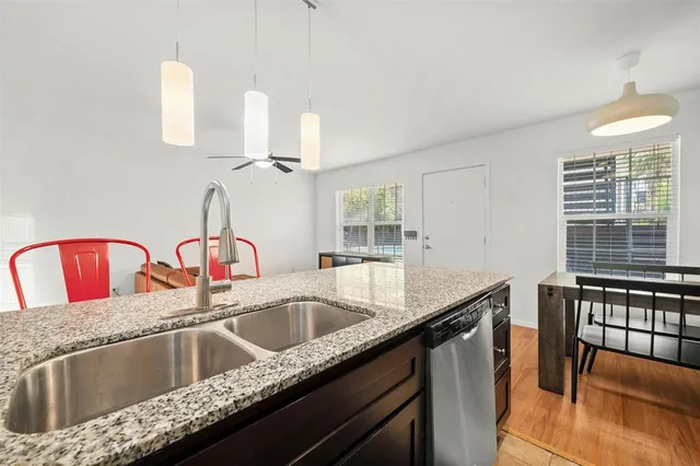 a kitchen with granite countertop a sink and a window