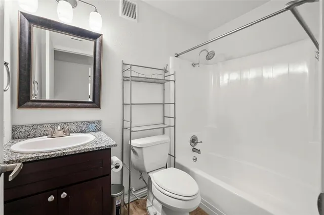 a bathroom with a sink toilet vanity and shower