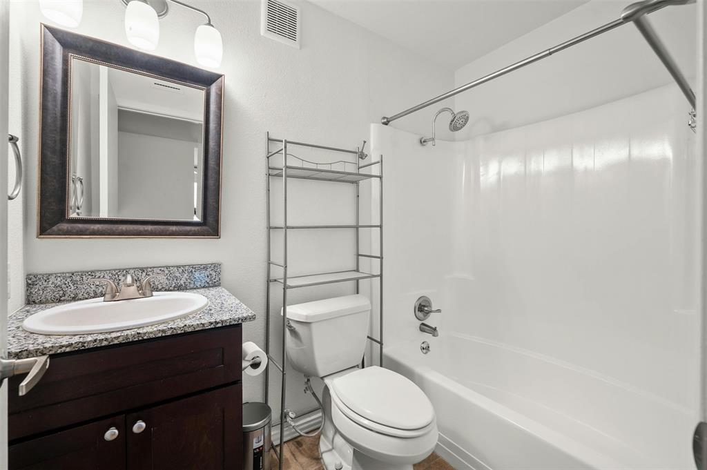 910 Duncan Lane, Unit 19 Austin, TX 78705 - Photo 8 of 13 a bathroom with a sink toilet vanity and shower