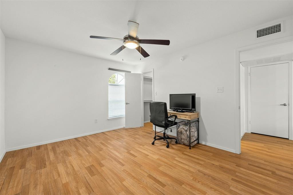 910 Duncan Lane, Unit 19 Austin, TX 78705 - Photo 10 of 13 a view of a workspace with wooden floor and a ceiling fan