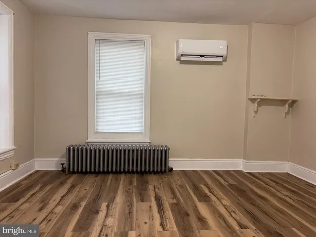 a view of a room with wooden floor