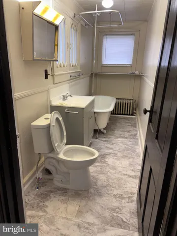 a bathroom with a toilet a sink and a mirror