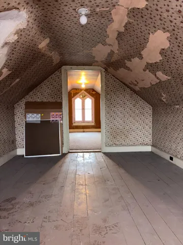 a view of an empty room with a fireplace and a window