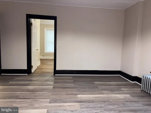 a view of a room with wooden floor